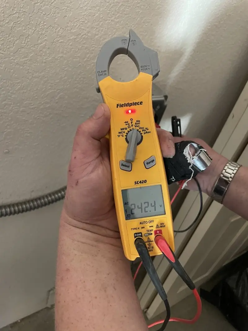 Voltage testing with clamp meter during Recessed Lighting Installation in Louisburg